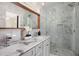 Bathroom featuring a marble vanity with dual sinks and a frameless glass enclosed shower at 2999 San Juan Dr, Decatur, GA 30032