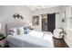 Bright bedroom featuring a sliding barn door to bathroom and a plush bed with decorator pillows at 2999 San Juan Dr, Decatur, GA 30032