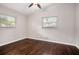 Cozy bedroom with hardwood floors, two windows, and ceiling fan at 2999 San Juan Dr, Decatur, GA 30032