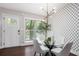 Bright dining area with hardwood floors, modern lighting, and a decorative patterned wall for an elegant and inviting atmosphere at 2999 San Juan Dr, Decatur, GA 30032