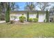 Charming ranch home with a well-manicured lawn, beautiful landscaping, and a welcoming yellow front door at 2999 San Juan Dr, Decatur, GA 30032