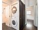 Hallway with stackable washer/dryer and sliding barn door at 2999 San Juan Dr, Decatur, GA 30032
