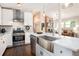 Modern kitchen featuring stainless steel appliances, a farmhouse sink, and marble countertops for a luxurious cooking experience at 2999 San Juan Dr, Decatur, GA 30032