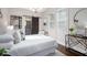 Serene main bedroom with ample natural light, a decorative mirror, and a barn door that leads to the ensuite bathroom at 2999 San Juan Dr, Decatur, GA 30032