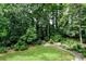 Lush backyard features a stone pathway leading through meticulously maintained landscaping at 3776 N Stratford Ne Rd, Atlanta, GA 30342