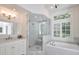 Marble tiled bathroom featuring a walk-in shower and soaking tub at 3776 N Stratford Ne Rd, Atlanta, GA 30342
