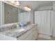 Bright bathroom featuring a double vanity with granite countertop and a shower with a white curtain at 3776 N Stratford Ne Rd, Atlanta, GA 30342