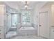 Marble tiled bathroom featuring a walk-in shower and soaking tub at 3776 N Stratford Ne Rd, Atlanta, GA 30342