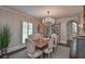Elegant dining room featuring textured wallpaper, a chandelier, and sophisticated decor at 3776 N Stratford Ne Rd, Atlanta, GA 30342