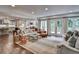 Open concept living room with a view of a modern kitchen and an outdoor patio at 3776 N Stratford Ne Rd, Atlanta, GA 30342