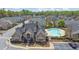 A picturesque community featuring a sparkling pool and well-maintained landscaping, perfect for relaxed living at 241 Orchards Cir, Woodstock, GA 30188