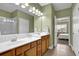 Ensuite bathroom with dual sink vanity and neutral tiling at 241 Orchards Cir, Woodstock, GA 30188