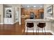 Modern kitchen with granite countertops, wood cabinets, and seating at the island at 241 Orchards Cir, Woodstock, GA 30188