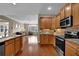 Spacious kitchen open to the living area, featuring granite counters and stainless steel appliances at 241 Orchards Cir, Woodstock, GA 30188