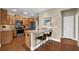Eat-in kitchen featuring stainless steel appliances, granite counters, and breakfast bar seating at 241 Orchards Cir, Woodstock, GA 30188