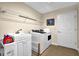 Laundry room with a white washer and dryer and utility sink at 241 Orchards Cir, Woodstock, GA 30188