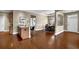 Bright and airy living room with hardwood floors, modern kitchen with granite counters, and an adjacent dining area at 241 Orchards Cir, Woodstock, GA 30188