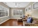 Bright living room featuring hardwood floors, large windows, and comfortable seating at 241 Orchards Cir, Woodstock, GA 30188
