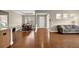 Open-concept living room featuring hardwood floors, a dining area, and comfortable seating at 241 Orchards Cir, Woodstock, GA 30188