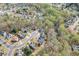 Aerial view showcasing home in a wooded neighborhood at 3743 Southland Dr, Buford, GA 30519
