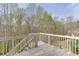 Wooden back deck overlooking a wooded area with lush greenery and scenic views at 3743 Southland Dr, Buford, GA 30519