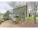 Two story home showcasing deck access to backyard and lush greenery at 3743 Southland Dr, Buford, GA 30519