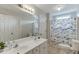 Bathroom with double sink vanity, a large mirror, and a fish-themed shower curtain at 3743 Southland Dr, Buford, GA 30519