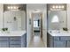 Bright bathroom features double sinks, large mirrors, and a view into the bedroom at 3743 Southland Dr, Buford, GA 30519