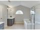 Bright bathroom boasts tile floors, vanity with sink, soaking tub, and glass shower at 3743 Southland Dr, Buford, GA 30519