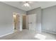 A carpeted bedroom shows doorways to the bathroom and closet at 3743 Southland Dr, Buford, GA 30519