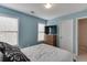 Comfortable bedroom with blue walls, carpet, and two windows providing natural light at 3743 Southland Dr, Buford, GA 30519