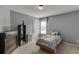 Bedroom features neutral paint, carpet, and a bright window at 3743 Southland Dr, Buford, GA 30519