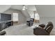 Large bonus room with vaulted ceiling, two arm chairs, and natural light at 3743 Southland Dr, Buford, GA 30519