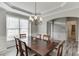 Formal dining room with a decorative chandelier, wainscoting, and natural light from the window at 3743 Southland Dr, Buford, GA 30519