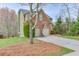 Two-story home with two-car garage and basketball hoop, complemented by mature trees and landscaping at 3743 Southland Dr, Buford, GA 30519