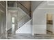 Welcoming foyer features soaring ceilings, hardwood floors, and a staircase leading to the upper level at 3743 Southland Dr, Buford, GA 30519