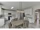 Bright kitchen with white cabinets, granite countertops, stainless steel appliances, and a large island with seating at 3743 Southland Dr, Buford, GA 30519