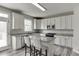 Eat-in kitchen featuring stainless appliances, gray countertops, white cabinets, and gray wood-look flooring at 3743 Southland Dr, Buford, GA 30519
