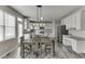 Spacious kitchen features white cabinets, gray countertops, stainless steel appliances, and a dining table at 3743 Southland Dr, Buford, GA 30519