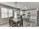 Modern kitchen with white cabinetry, stainless steel appliances, a gray tile backsplash, and a breakfast nook at 3743 Southland Dr, Buford, GA 30519