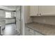 Bright kitchen with white cabinets, granite countertops, and stainless steel appliances at 3743 Southland Dr, Buford, GA 30519