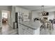 Open-concept kitchen with stainless steel appliances, gray countertops, island with seating, and access to the living area at 3743 Southland Dr, Buford, GA 30519