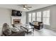 Inviting living room features a cozy fireplace, large windows for natural light, and comfortable seating arrangements at 3743 Southland Dr, Buford, GA 30519