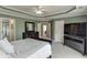 Large main bedroom with a tray ceiling, dresser, and access to the en-suite bathroom at 3743 Southland Dr, Buford, GA 30519