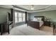 Spacious main bedroom featuring a ceiling fan, tray ceiling, and a large window at 3743 Southland Dr, Buford, GA 30519