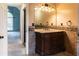 Bathroom vanity with dual sinks, decorative tile backsplash, lighting, and access to bedroom at 703 Paul Revere Dr, Locust Grove, GA 30248