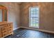 Bedroom with wood floors and a dresser at 703 Paul Revere Dr, Locust Grove, GA 30248