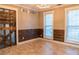 Bright room boasting wood-paneled accent wall and sun-filled windows at 703 Paul Revere Dr, Locust Grove, GA 30248