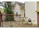 Wooden deck with a table and railing, perfect for outdoor relaxation and entertaining at 703 Paul Revere Dr, Locust Grove, GA 30248
