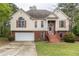 Traditional two-story home with a two-car garage, red shutters, and landscaped front yard at 703 Paul Revere Dr, Locust Grove, GA 30248